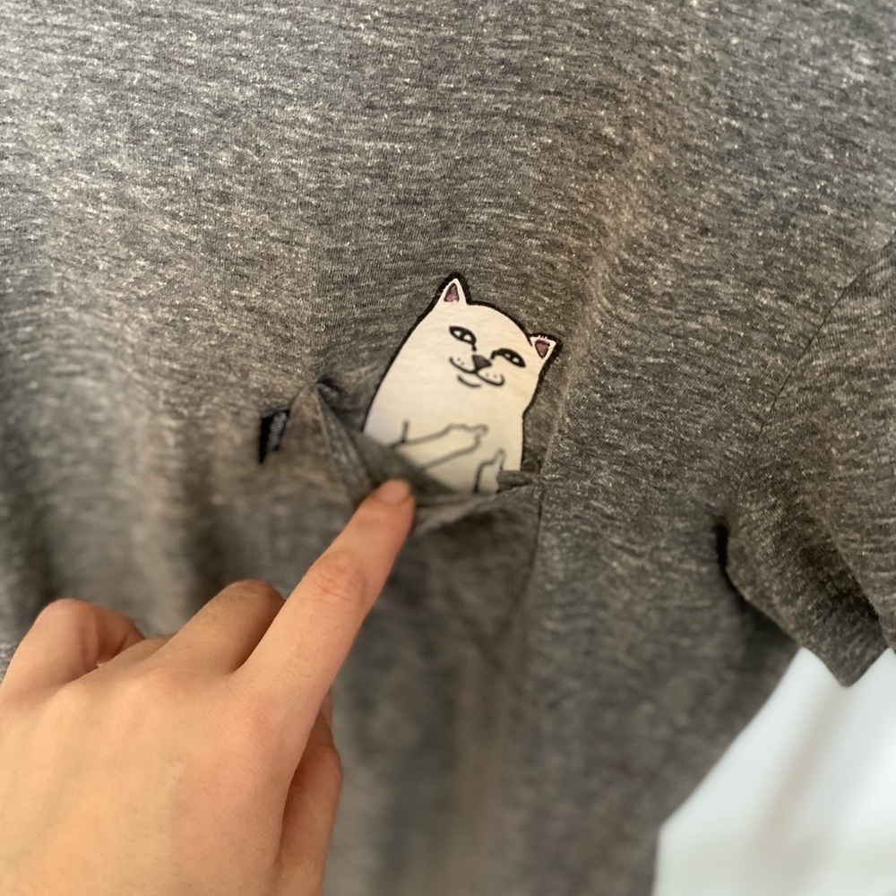 Cat flipping off in pocket shirt
